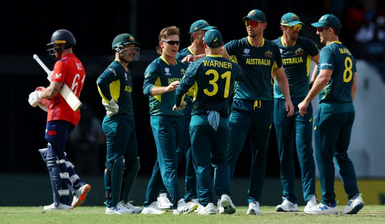 Australia's Adam Zampa celebrates with teammates after taking the wicket of England's Phil Salt